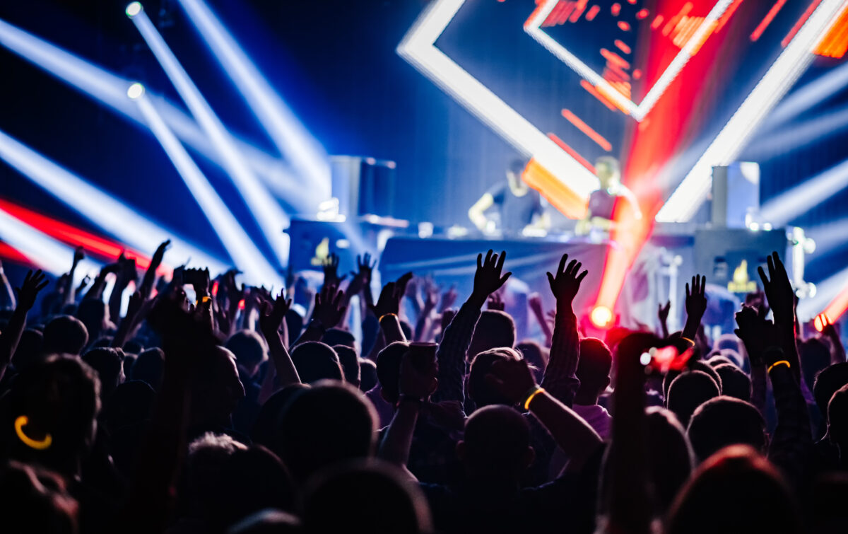 Dj,Party,At,Nightclub.,Crowd,Rave,At,The,Stage,Background.