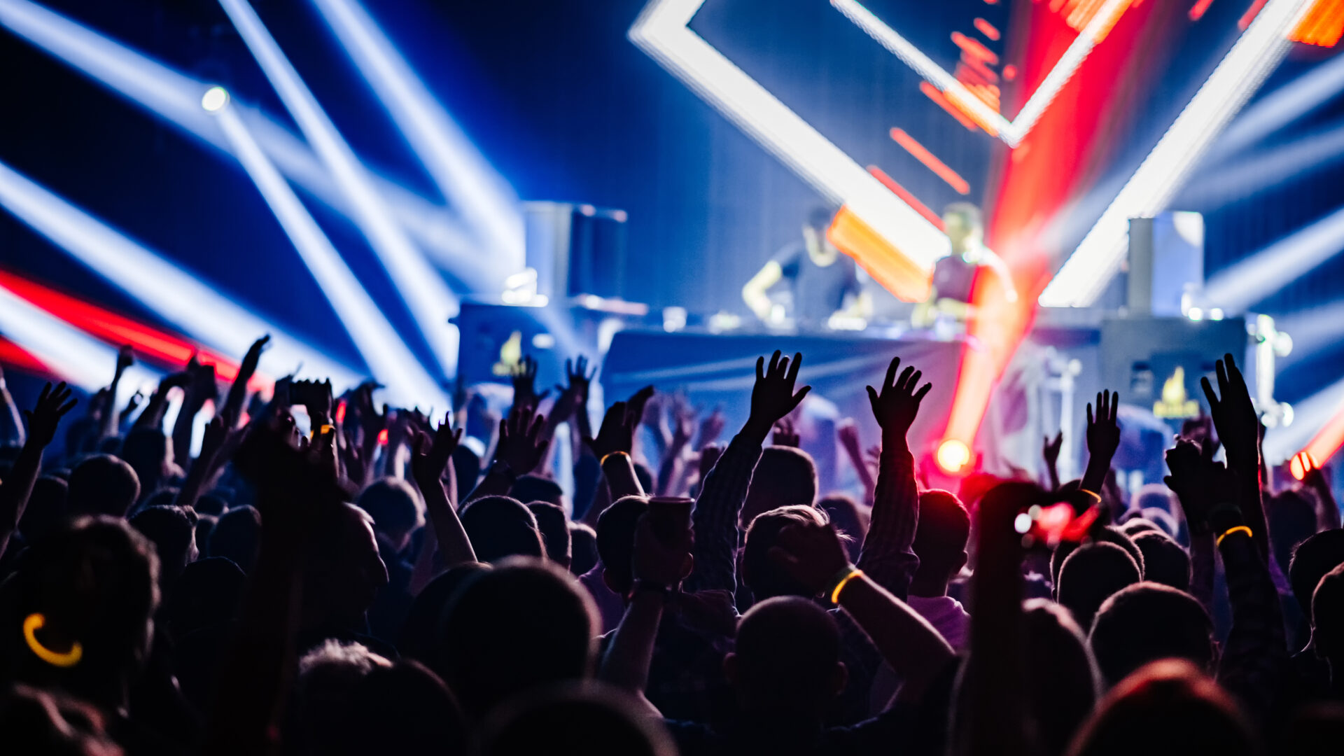 Dj,Party,At,Nightclub.,Crowd,Rave,At,The,Stage,Background.
